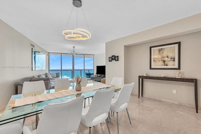 3101 S Ocean Dr Unit 2307, Hollywood, FL 33019 - dining room with a wall of windows, a notable chandelier, and baseboards