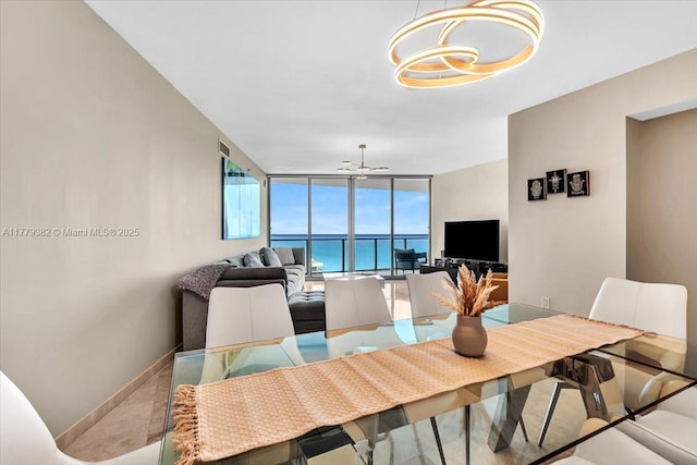 3101 S Ocean Dr Unit 2307, Hollywood, FL 33019 - dining room with a wall of windows, an inviting chandelier, and baseboards
