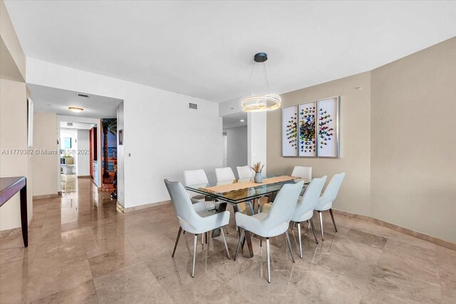3101 S Ocean Dr Unit 2307, Hollywood, FL 33019 - dining space with baseboards and visible vents