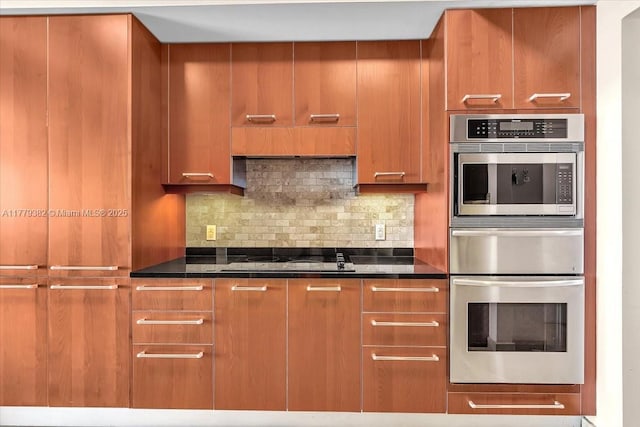 3101 S Ocean Dr Unit 2307, Hollywood, FL 33019 - kitchen with modern cabinets, brown cabinetry, double oven, black electric stovetop, and decorative backsplash