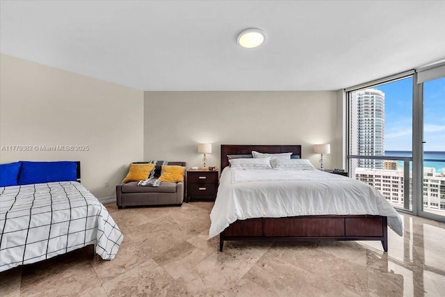 3101 S Ocean Dr Unit 2307, Hollywood, FL 33019 - bedroom with a water view, expansive windows, and baseboards