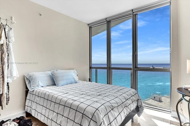 3101 S Ocean Dr Unit 2307, Hollywood, FL 33019 - bedroom with floor to ceiling windows, multiple windows, baseboards, and a water view