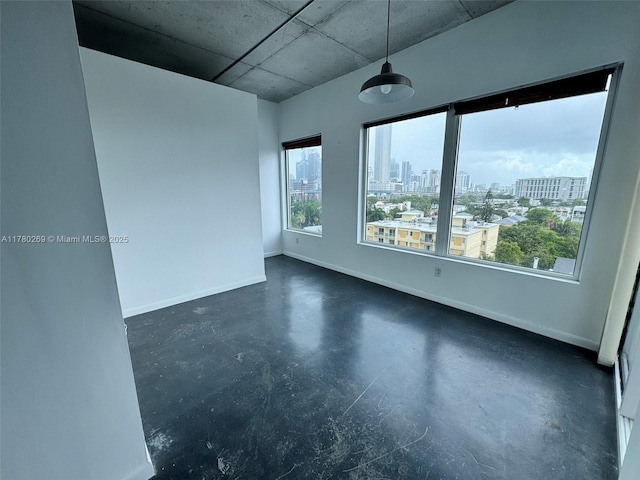 10 SW S River Dr Unit 812, Miami, FL 33130 - unfurnished room featuring concrete flooring, a city view, and baseboards