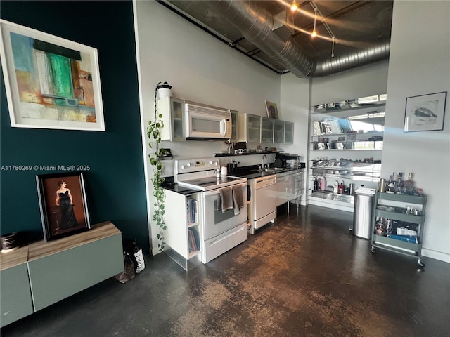 10 SW S River Dr Unit 812, Miami, FL 33130 - kitchen with white appliances, a sink, a high ceiling, open shelves, and finished concrete flooring