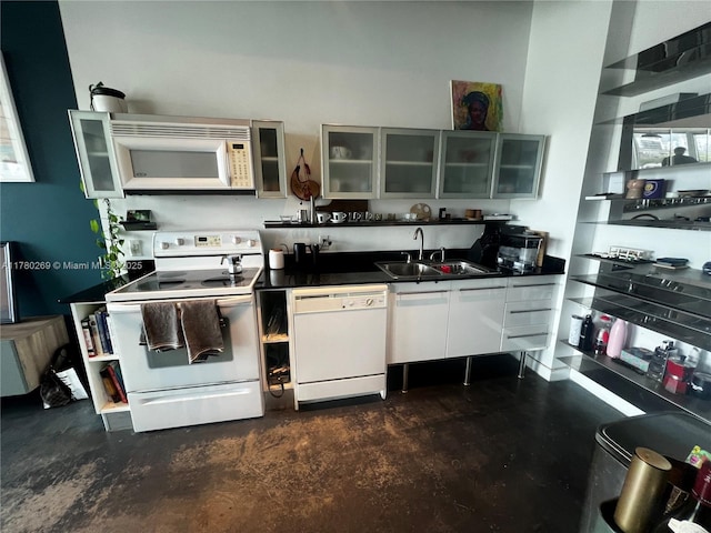 10 SW S River Dr Unit 812, Miami, FL 33130 - kitchen featuring white appliances, a sink, dark countertops, and glass insert cabinets