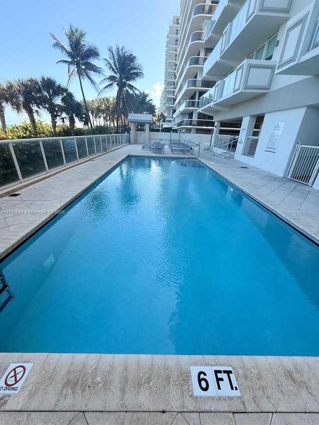 9499 Collins Ave Unit 411, Surfside, FL 33154 - community pool featuring a patio area