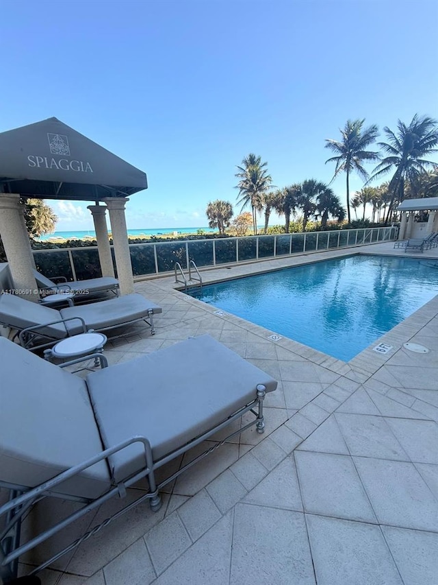 9499 Collins Ave Unit 411, Surfside, FL 33154 - community pool featuring a patio area