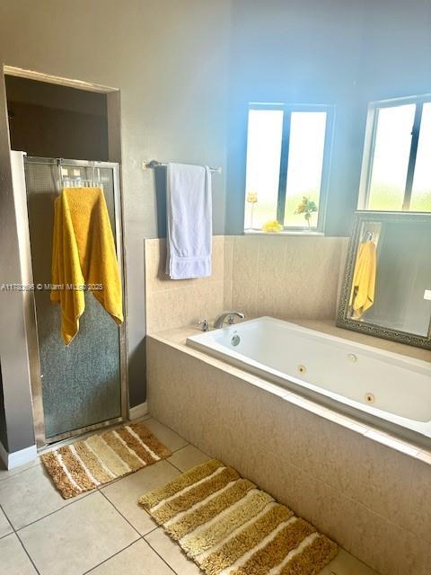 3315 18 W, Lehigh Acres, FL 33971 - bathroom featuring a stall shower, tile patterned flooring, and a whirlpool tub