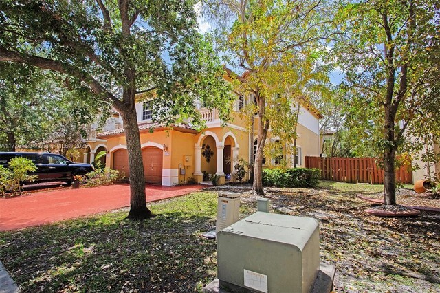 14070 SW 50th Ct, Miramar, FL 33027 - mediterranean / spanish home with stucco siding, fence, a tile roof, and an attached garage