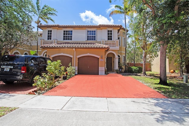 14070 SW 50th Ct, Miramar, FL 33027 - mediterranean / spanish-style house with a tile roof, stucco siding, decorative driveway, a balcony, and fence