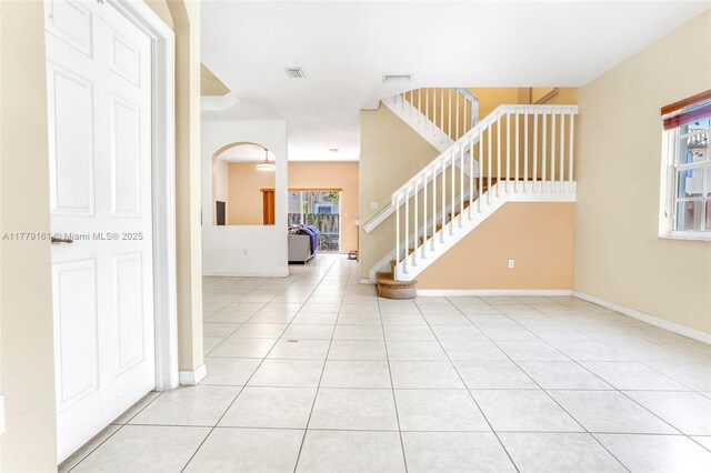 14070 SW 50th Ct, Miramar, FL 33027 - foyer with stairway, light tile patterned floors, baseboards, and arched walkways