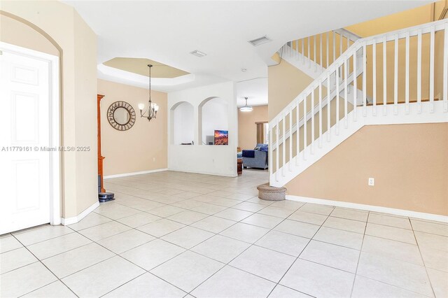 14070 SW 50th Ct, Miramar, FL 33027 - foyer entrance with stairs, light tile patterned flooring, baseboards, a raised ceiling, and a chandelier