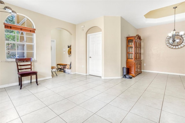 14070 SW 50th Ct, Miramar, FL 33027 - spare room with arched walkways, a chandelier, light tile patterned floors, and baseboards