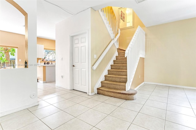 14070 SW 50th Ct, Miramar, FL 33027 - stairs with tile patterned floors, arched walkways, and baseboards