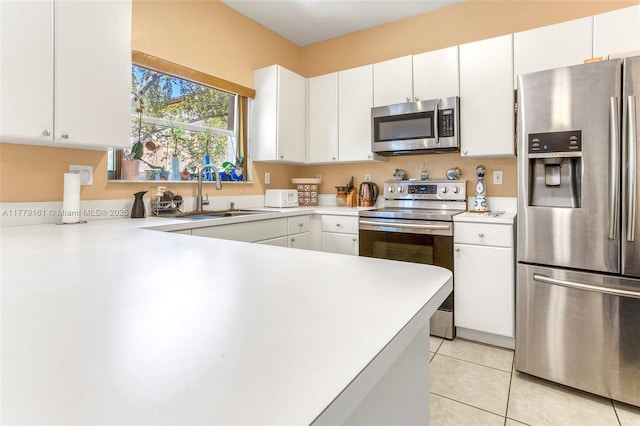 14070 SW 50th Ct, Miramar, FL 33027 - kitchen featuring stainless steel appliances, a sink, light countertops, white cabinets, and light tile patterned floors