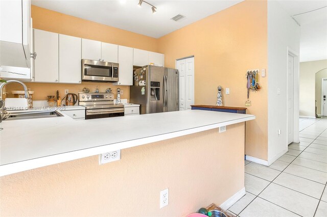 14070 SW 50th Ct, Miramar, FL 33027 - kitchen featuring appliances with stainless steel finishes, a sink, light tile patterned floors, and light countertops