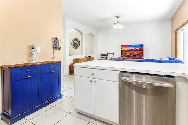 14070 SW 50th Ct, Miramar, FL 33027 - kitchen with stainless steel dishwasher, light tile patterned floors, open floor plan, white cabinets, and arched walkways