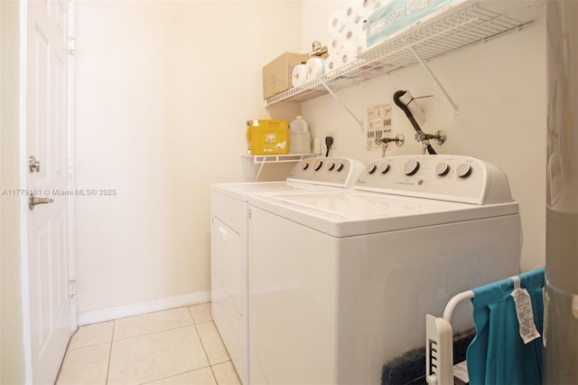 14070 SW 50th Ct, Miramar, FL 33027 - washroom with washer and dryer, light tile patterned floors, and baseboards