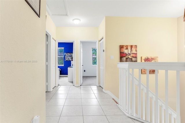 14070 SW 50th Ct, Miramar, FL 33027 - corridor featuring baseboards, light tile patterned floors, and light colored carpet