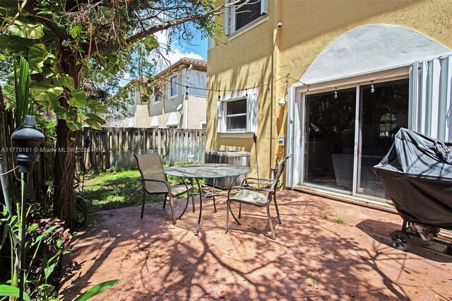 14070 SW 50th Ct, Miramar, FL 33027 - view of patio / terrace with central AC unit, a fenced backyard, and outdoor dining area