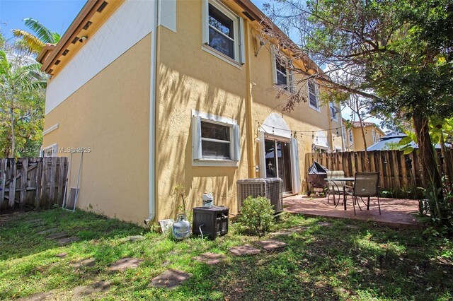 14070 SW 50th Ct, Miramar, FL 33027 - rear view of house featuring cooling unit, stucco siding, fence, and a patio