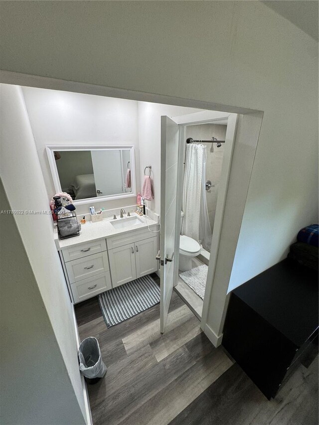 1235 Mariposa Ave Unit 1, Coral Gables, FL 33146 - bathroom with toilet, a shower with curtain, vanity, and wood finished floors