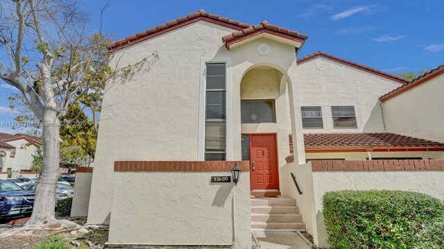 331 Ives Dairy Rd Unit 331-09, Miami, FL 33179 - view of front of property featuring a tile roof and stucco siding