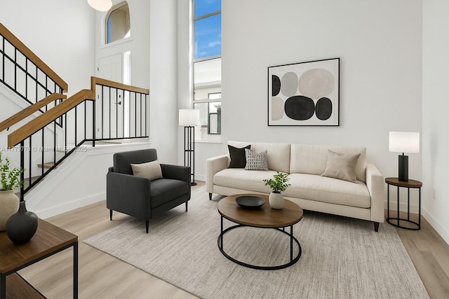 331 Ives Dairy Rd Unit 331-09, Miami, FL 33179 - living room featuring wood finished floors, a towering ceiling, plenty of natural light, baseboards, and stairway