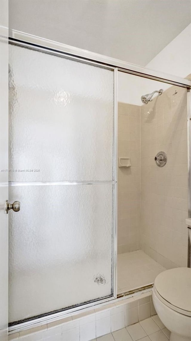 331 Ives Dairy Rd Unit 331-09, Miami, FL 33179 - full bath featuring a stall shower, tile patterned floors, and toilet