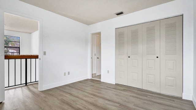 331 Ives Dairy Rd Unit 331-09, Miami, FL 33179 - unfurnished bedroom featuring wood finished floors, a closet, and baseboards