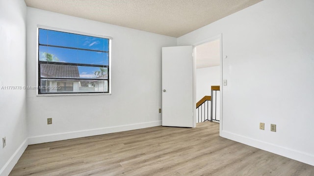 331 Ives Dairy Rd Unit 331-09, Miami, FL 33179 - spare room featuring light wood-style floors, a textured ceiling, and baseboards