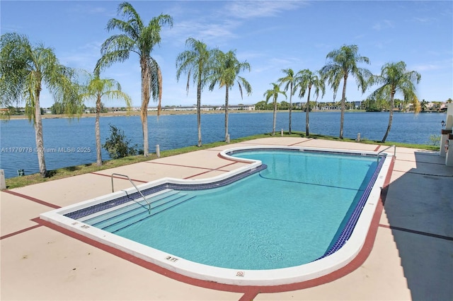 community pool featuring a patio and a water view