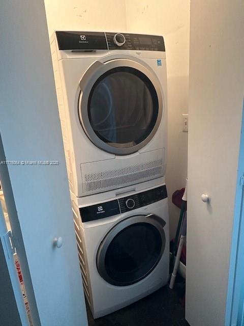 laundry area with stacked washer / dryer