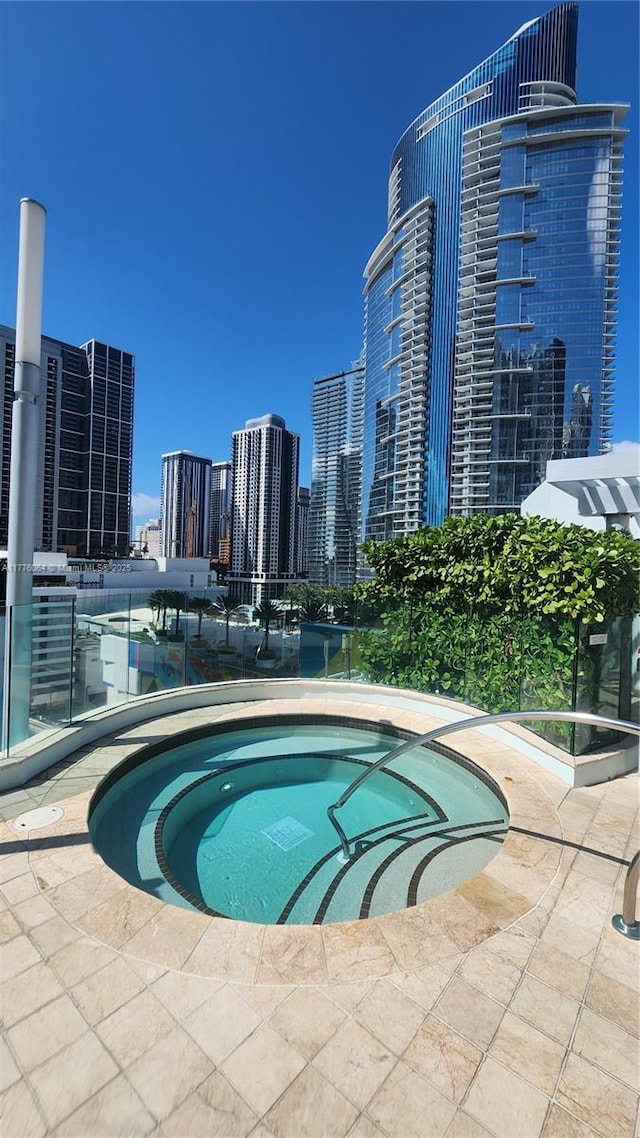 view of pool with a skyline view