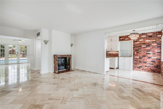 unfurnished living room with baseboards, a ceiling fan, visible vents, and a fireplace
