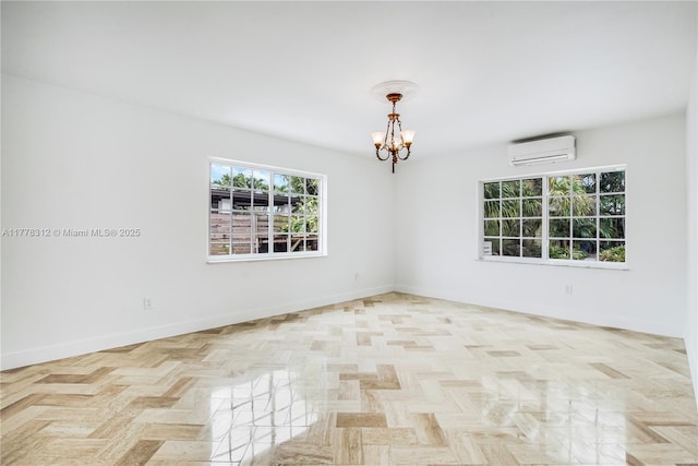 empty room with baseboards, an AC wall unit, and a chandelier