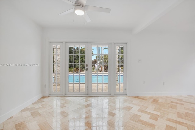 empty room with baseboards and ceiling fan