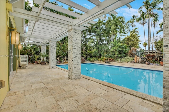 outdoor pool featuring a pergola and a patio area