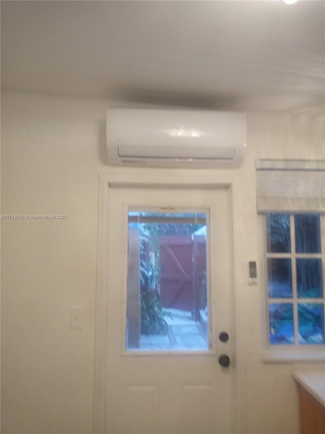 doorway featuring a wall unit AC
