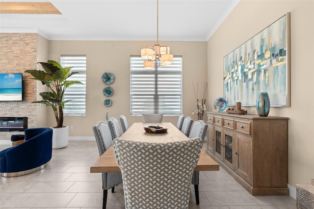 dining area featuring baseboards, an inviting chandelier, a fireplace, light tile patterned floors, and crown molding