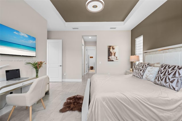 bedroom featuring a tray ceiling, light tile patterned floors, baseboards, and visible vents
