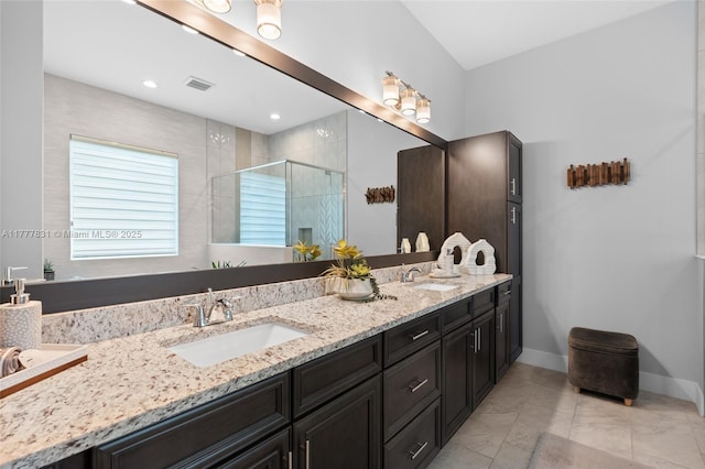 bathroom featuring double vanity, visible vents, a sink, and a stall shower