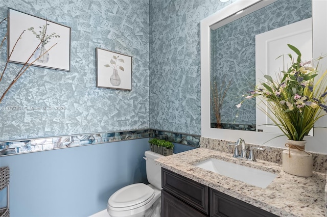 bathroom featuring toilet and vanity