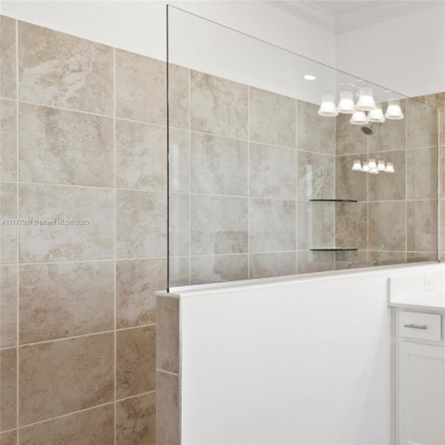 full bath featuring crown molding, a walk in shower, and vanity
