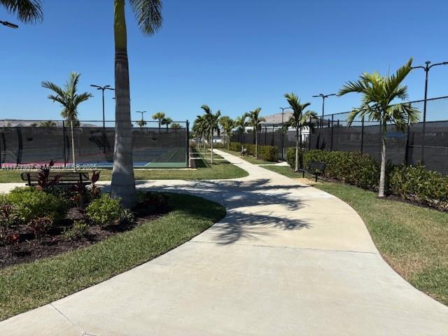 view of home's community with fence and a trampoline