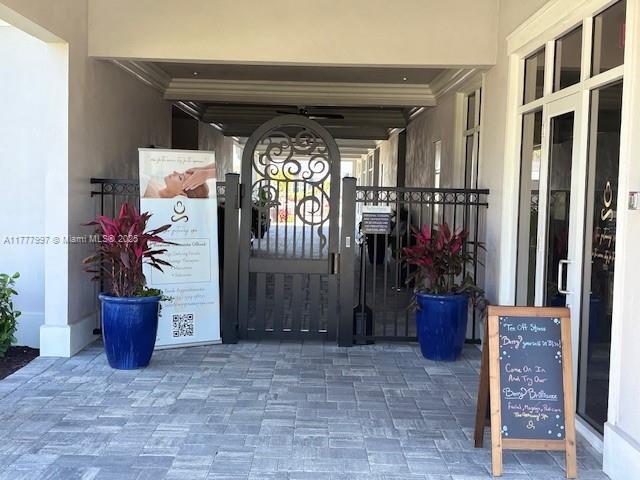 doorway to property with a gate and stucco siding