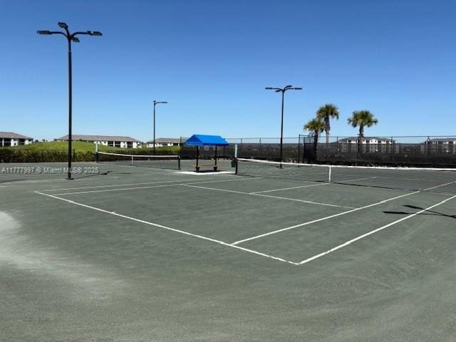 view of tennis court with fence