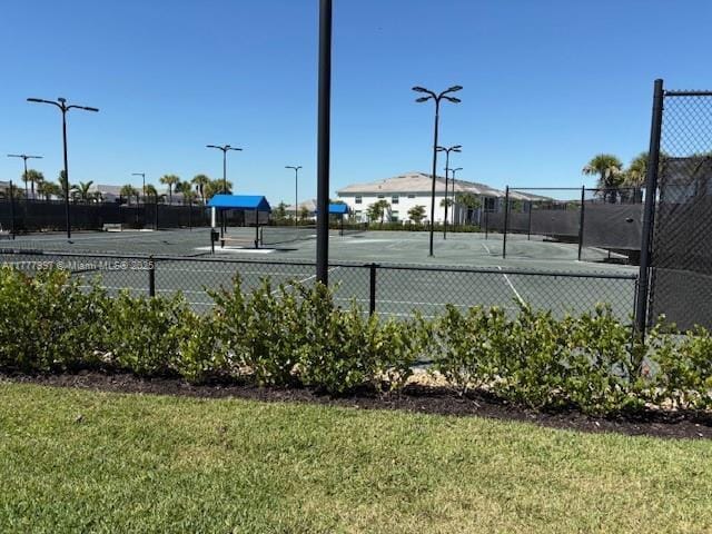 view of sport court featuring fence