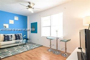 7326 Collins Ave Unit 102, Miami Beach, FL 33141 - living room with wood finished floors and baseboards