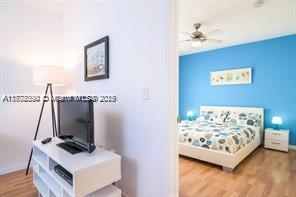 7326 Collins Ave Unit 102, Miami Beach, FL 33141 - bedroom with wood finished floors and baseboards